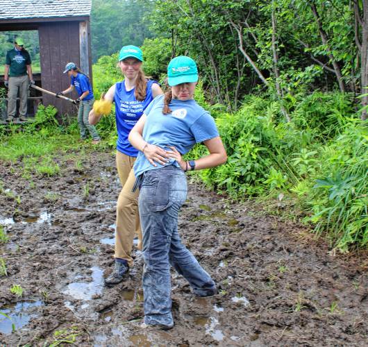 High School Trail Corps members Ann Buffington, of Enfield, left, and Heidi Ahlgren, of West Lebanon, right, take brief break from working at Chaffee Wildlife Sanctuary in Lyme. (Upper Valley Trails Alliance photograph)