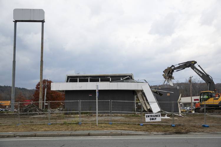 A crew works to demolish a defunct Irving gas station, which closed in 2010 when the I-89 overpass was rebuilt and Route 12A was widened leaving little room for gas pumps, in West Lebanon, N.H., on Tuesday, Nov. 7, 2023. Irving plans to redevelop the site along with the adjacent parcel where the former Kleen laundromat building is located, erecting a new convenience store and gas station. (Valley News / Report For America - Alex Driehaus) Copyright Valley News. May not be reprinted or used online without permission. Send requests to permission@vnews.com.