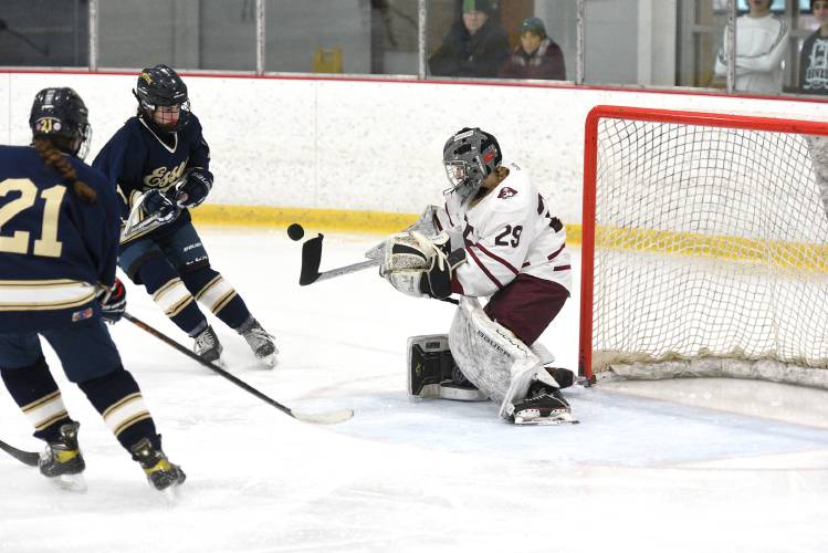 Hanover netminder Eleanor Edson makes a save in their consolation game with Essex during the Hanover Holiday Tournament on Thursday, Dec. 28, 2023, in West Lebanon, N.H. Skating towards goal are Essex's Lilliana Baldasaro and Lucia Minadeo. Hanover won, 7-0. (Valley News - Jennifer Hauck) Copyright Valley News. May not be reprinted or used online without permission. Send requests to permission@vnews.com.