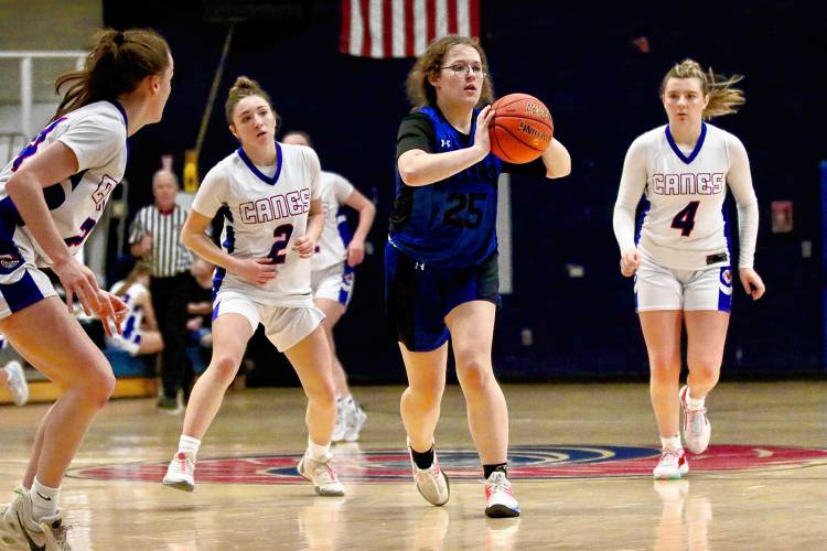 Otter Valley High's Elaina Sheldrick (25) is surrounded by Hartford defenders Gabby Gardner, left, Izzy Sirois (2) and Charlotte Jasmin (4) during the Hurricanes' 71-22 victory on Jan. 26, 2024, in White River Junction, Vt. (Valley News - Tris Wykes) Copyright Valley News. May not be reprinted or used online without permission.