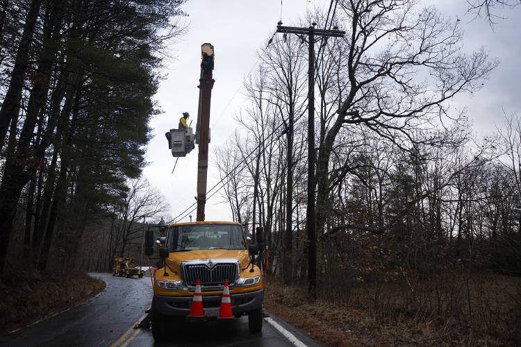 An Eversource crew returns power to transmission lines after repairing a downed utility pole on Town House Road in Cornish, N.H., on Monday, Dec. 18, 2023. A portion of Town House Round was closed for several hours during the repairs. (Valley News / Report For America - Alex Driehaus) Copyright Valley News. May not be reprinted or used online without permission. Send requests to permission@vnews.com.