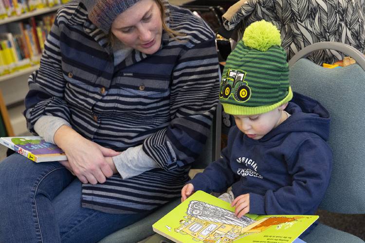 Anna Marie DeVito, left, reads a book with her son Max DeVito, 2, both of Hartland, Vt., during story time at the Hartland Public Library in Hartland, Vt., on Saturday, Jan. 20, 2024. (Valley News / Report For America - Alex Driehaus) Copyright Valley News. May not be reprinted or used online without permission. Send requests to permission@vnews.com.