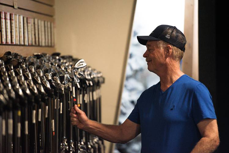 Tim Rockwood, of Hartland, checks out a club while waiting for his wife who was shopping for a new set at Golf and Ski Warehouse in West Lebanon, N.H., on Friday, June 23, 2023. Rockwood, a surveyor, said he surveyed the land that the store now sits on during the permitting process. (Valley News - James M. Patterson) Copyright Valley News. May not be reprinted or used online without permission. Send requests to permission@vnews.com.
