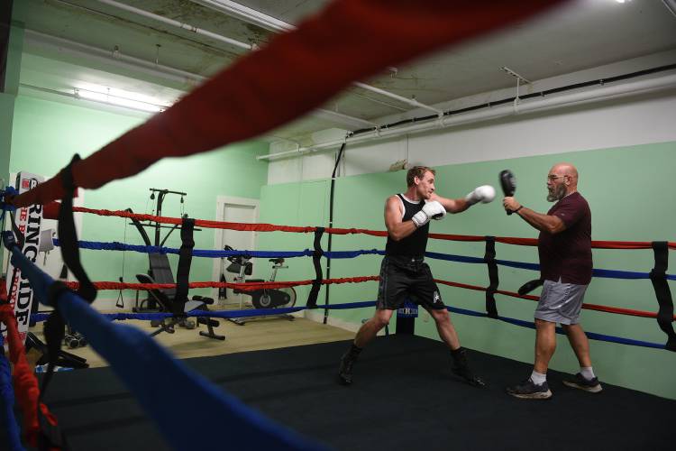 Boxer Nicholas Kane, of White River Junction, Vt., trains in a sparring ring with head coach Ron 