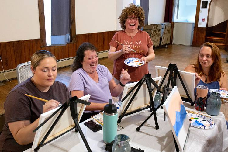 Student Christine Dobrich, of Sharon, Vt., second from left, and instructor Christine Traverson enjoy a laugh during a Bob Ross Paint Night session at the Seven Stars Arts Center in Sharon on Sept. 8, 2023. Maddi Smith, of Sharon, left, and Morgan Brophy, also of Sharon, work on their paintings as well. Traverson regularly holds painting sessions throughout the area. (Valley News - Geoff Hansen) Copyright Valley News. May not be reprinted or used online without permission. Send requests to permission@vnews.com.