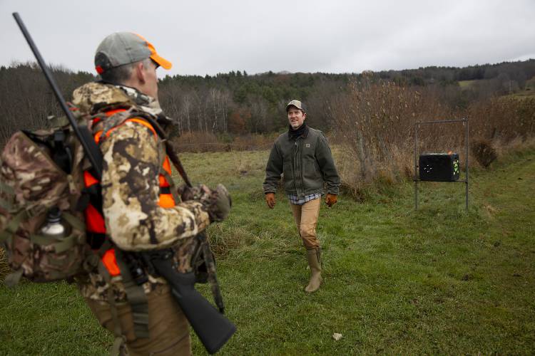 Martin Philip, left, of White River Junction, Vt., talks to John Lamppa after spending the morning hunting on his property in Norwich, Vt., on Saturday, Nov. 18, 2023. Lamppa welcomes friends onto his land to hunt in the hopes that it will help to reduce the number of deer, which have been causing damage to his hazelnut trees and limiting forest regeneration. “They just came in and ate anything they could find,” Lamppa said of the deer during the drought conditions in 2022. (Valley News / Report For America - Alex Driehaus) Copyright Valley News. May not be reprinted or used online without permission. Send requests to permission@vnews.com.