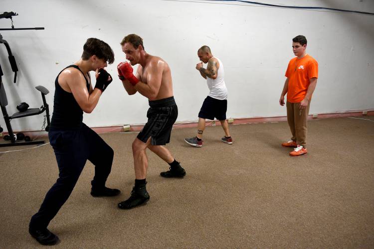 Boxer Nicholas Kane, of White River Junction, Vt., second from left works on footwork with fellow boxers Alex Laroche, of Claremont, N.H. Eric Rheault, of Claremont, and Luke Forrest, of Claremont, on Wednesday, July 26, 2023. Forrest also coaches at the center. (Valley News - Jennifer Hauck) Copyright Valley News. May not be reprinted or used online without permission. Send requests to permission@vnews.com.