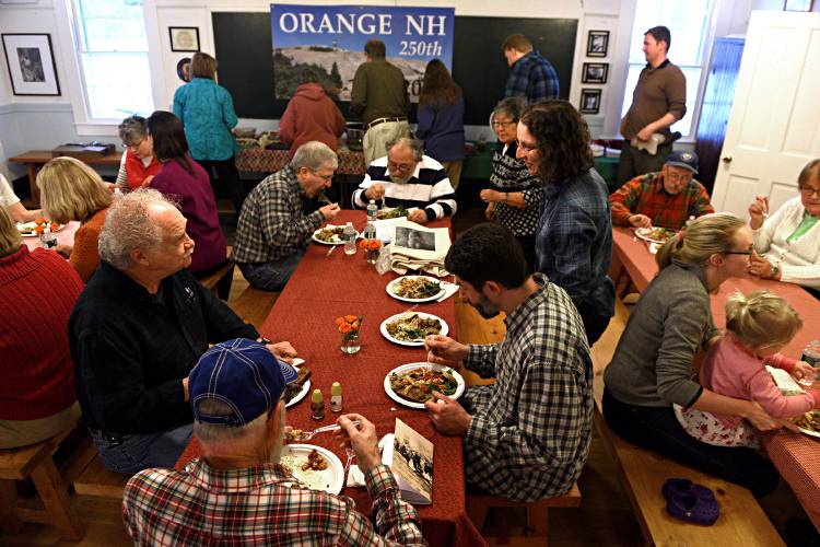 Residents of Orange, N.H., sit down for a potluck dinner before their annual Town Meeting on March 13, 2019. The town is celebrating its 250th anniversary this year. (Valley News - Jennifer Hauck) Copyright Valley News. May not be reprinted or used online without permission. Send requests to permission@vnews.com.