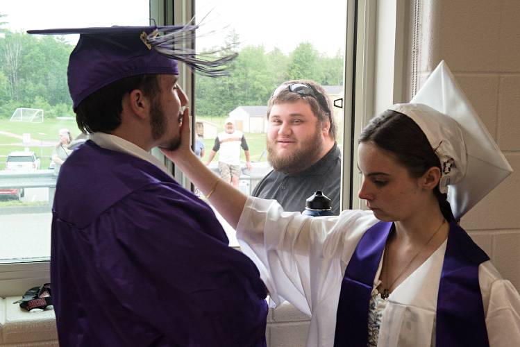 Ceeanna Crandall, right, turns Ryan Gilliland, left, away from the window where he was talking with Matthew Farewell, middle, to listen to instructions from the Mascoma High School Class of 2023 advisors before commencement in West Canaan, N.H., on Friday, June 16, 2023. Farewell was a Mascoma student before transferring to the Ledyard Charter School and graduating in 2020. (Valley News - James M. Patterson) Copyright Valley News. May not be reprinted or used online without permission. Send requests to permission@vnews.com.