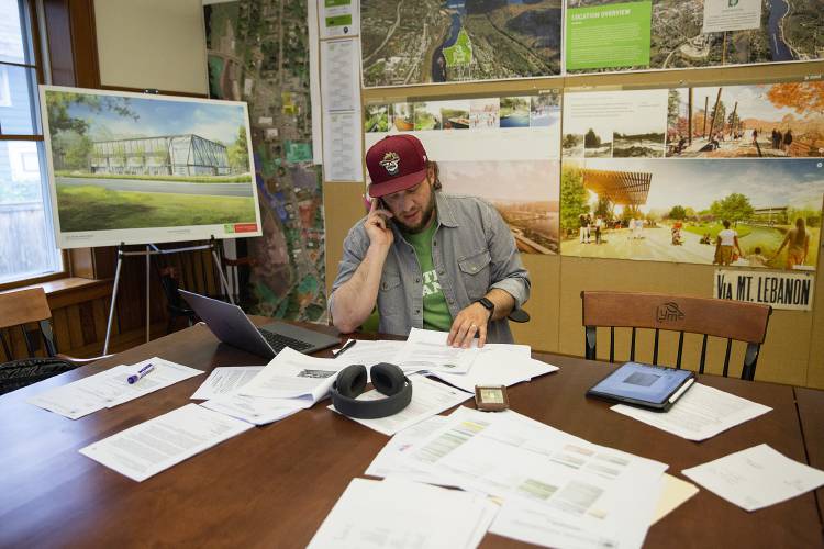 Lyme Properties President Chet Clem works at the real estate development company’s office in West Lebanon, N.H., on Wednesday, May 24, 2023. Lyme Properties purchased the land for River Park in 2007, and since breaking ground in 2015 the project has experienced numerous delays. The first of several proposed buildings has yet to be built. (Valley News / Report For America - Alex Driehaus) Copyright Valley News. May not be reprinted or used online without permission. Send requests to permission@vnews.com.