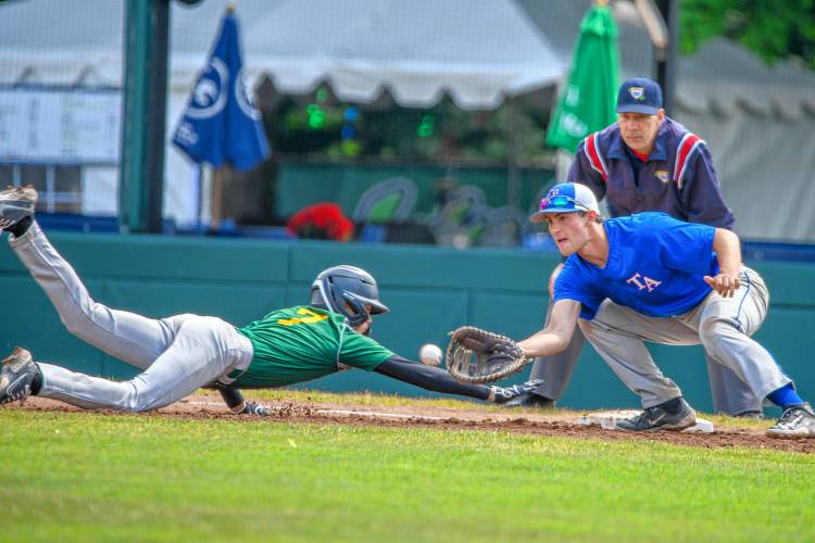 White River Valley's Jacob Benoit slides into first ahead of a pick-off attempt while Thetford's Justin Robinson covers the base during Saturday's D-III championship in Burlington. (Tim Calabro / White River Valley Herald)