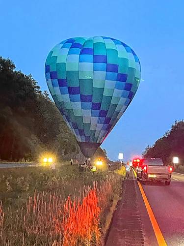 A hot air balloon landed in the Interstate 91 median in White River Junction, Vt., on Wednesday night, August 23, 2023. Hartford firefighter Mitch White photographed its landing. (Mitch White photograph)