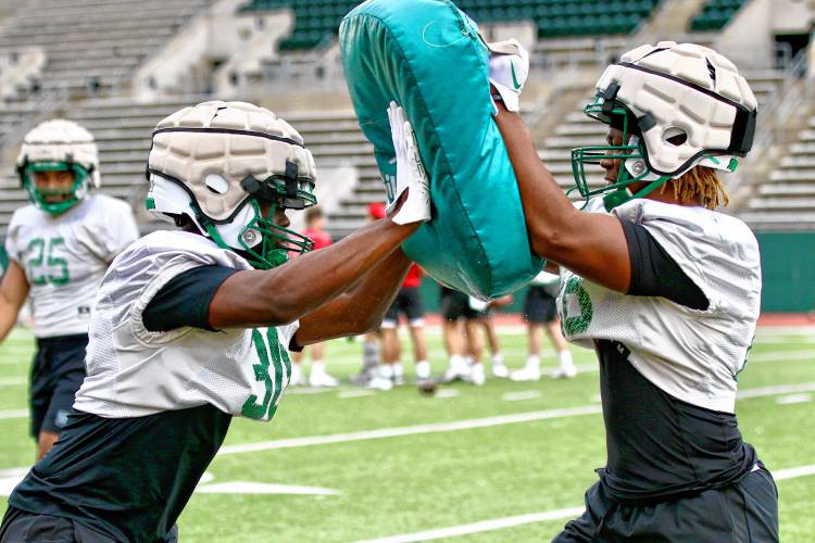 Dartmouth College's Jorden Barnes, left, and K.J. Edwards participate in a blocking drill during their team's opening practice on Aug. 19, 2023, at Memorial Field in Hanover, N.H. (Valley News - Tris Wykes) Copyright Valley News. May not be reprinted or used online without permission. Send requests to permission@vnews.com.