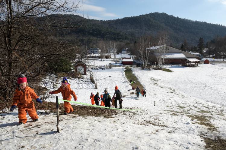 Gwendolyn Ogreen, left, and Adaline Sabonis, second from left, lead their pre-kindergarten class up the sledding hill on the grounds of Sharon Elementary, built in 1989, on Thursday, Nov. 30, 2023. The Sharon School Board is proposing to renovate and expand the building. (Valley News - James M. Patterson) Copyright Valley News. May not be reprinted or used online without permission. Send requests to permission@vnews.com.