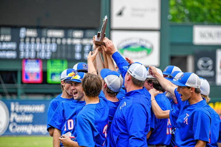 Thetford players celebrate with the D-III baseball trophy after the team's decisive win over White River Valley on Saturday in Burlington. (Tim Calabro / White River Valley Herald)