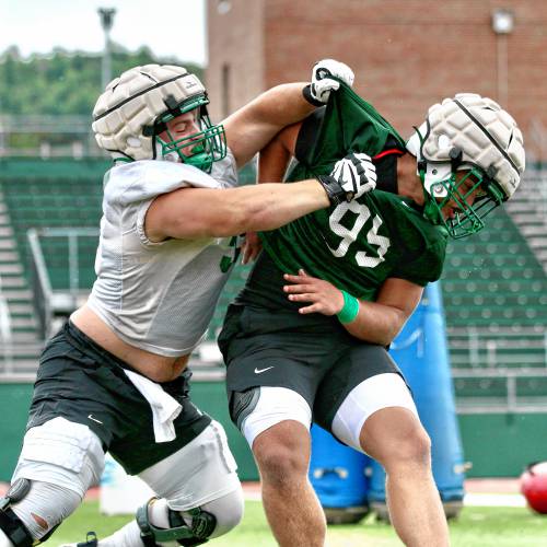 Dartmouth College's Nick Marinaro, left, blocks Bruce Williams during the Big Green's opening preseason practice on Aug. 19, 2023, at Memorial Field in Hanover, N.H. (Valley News - Tris Wykes) Copyright Valley News. May not be reprinted or used online without permission. Send requests to permission@vnews.com.