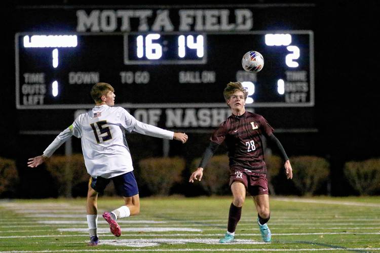 Lebanon High's Abe Pearson (28) and Bow's Elias Kerrigan watch an airborne ball during their teams' NHIAA Division II final on Nov. 3, 2023, at Stellos Stadium in Nashua, N.H. Bow won, 2-1. (Valley News - Tris Wykes) Copyright Valley News. May not be reprinted or used online without permission. Send requests to permission@vnews.com.