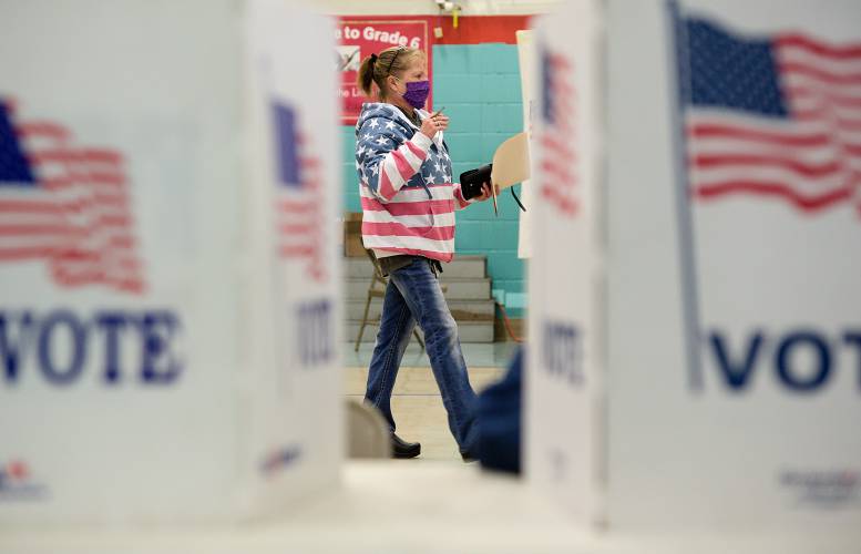Claremont, N.H., voter Kelly Bates steps up to a voting booth with her ballot at Claremont Middle School Tuesday, Nov. 3, 2020. (Valley News - James M. Patterson) Copyright Valley News. May not be reprinted or used online without permission. Send requests to permission@vnews.com.