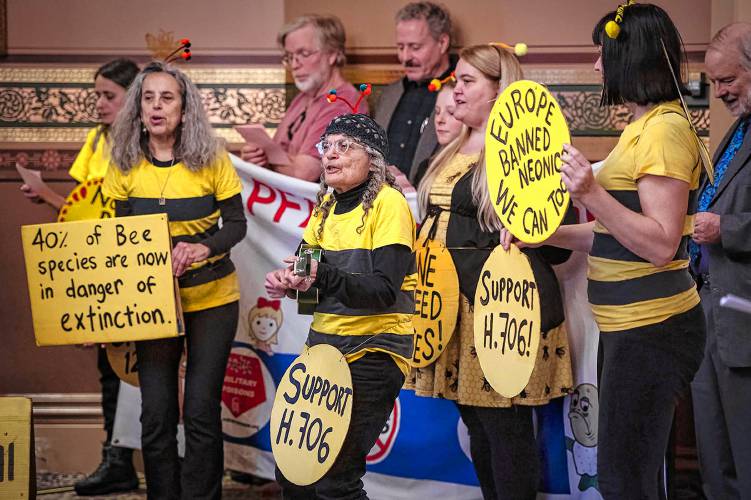 Aro Veno of East Montpelier, Vt., center, leads a singalong at the end of a press conference called to support a bill that would ban neonicotinoid pesticides at the Statehouse in Montpelier on Tuesday, Jan. 30, 2024. (VtDigger - Glenn Russell)
