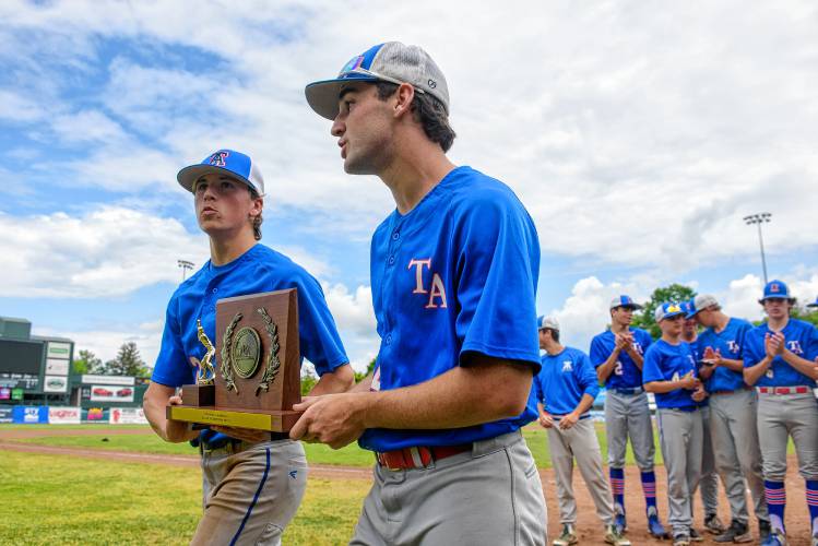 Thetford's seniors, Nolan Pepe and Jacob Gilman carry the D-III baseball title trophy after the Panthers' win over White River Valley on Saturday in Burlington. (Tim Calabro / White River Valley Herald)