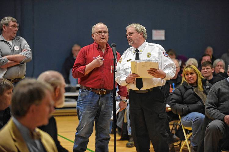 Orford Fire Chief Terry Straight, right, and Tim Cole voice their differing opinions about the Orford town budget during Town Meeting in Orford, N.H., on March 10, 2015. (Valley News - Sarah Priestap) Copyright Valley News. May not be reprinted or used online without permission. Send requests to permission@vnews.com.