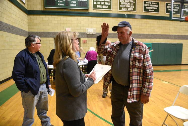 Larry Taylor is sworn in by Debbie Hadlock, Orford's town clerk and tax collector, for a three-year term on the Selectboard after the Orford Town Meeting on Tuesday, March 12, 2024 in Orford, N.H. Taylor beat out Selectboard Chairman John Adams for the seat. (Valley News - Jennifer Hauck) Copyright Valley News. May not be reprinted or used online without permission. Send requests to permission@vnews.com.