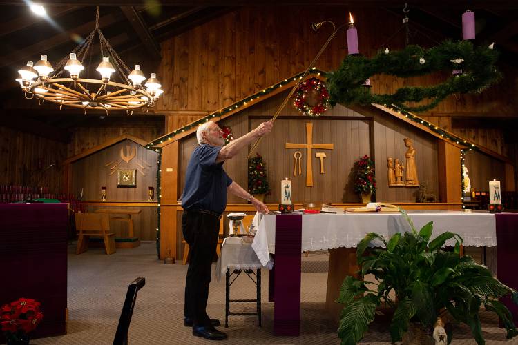 Father John Sullivan lights a candle on the Advent wreath as he prepares for daily Mass at the Shrine of Our Lady of La Salette in Enfield, N.H., on Wednesday, Nov. 30, 2022. La Salette’s North American Provincial Council is considering closing the shrine due to a dwindling number of priests. (Valley News / Report For America - Alex Driehaus) Copyright Valley News. May not be reprinted or used online without permission. Send requests to permission@vnews.com.