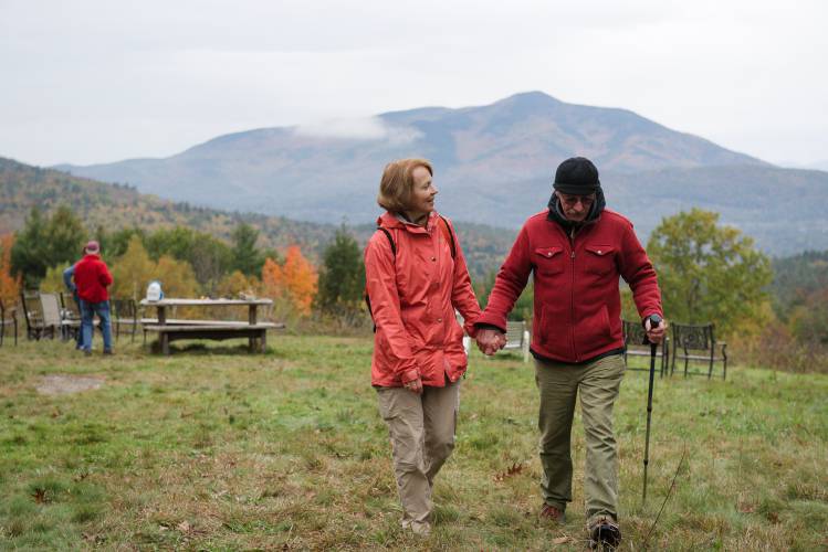 Colleen O’Neill, center, and John Bieling, of West Windsor, right, return to the trail at Langwood Tree Farm in Cornish, N.H., after sharing the view of Mount Ascutney with guests Hilda and Jack Dargon, left, of Watertown, Mass., on Wednesday, Oct. 18, 2023. O'Neill was named New Hampshire's Outstanding Tree Farmer of the Year by New Hampshire Timberland Owners Association in June. (Valley News - James M. Patterson) Copyright Valley News. May not be reprinted or used online without permission. Send requests to permission@vnews.com.