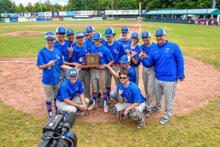 Thetford players celebrate with the D-III baseball trophy after the team's decisive win over White River Valley on Saturday in Burlington. (Tim Calabro / White River Valley Herald)