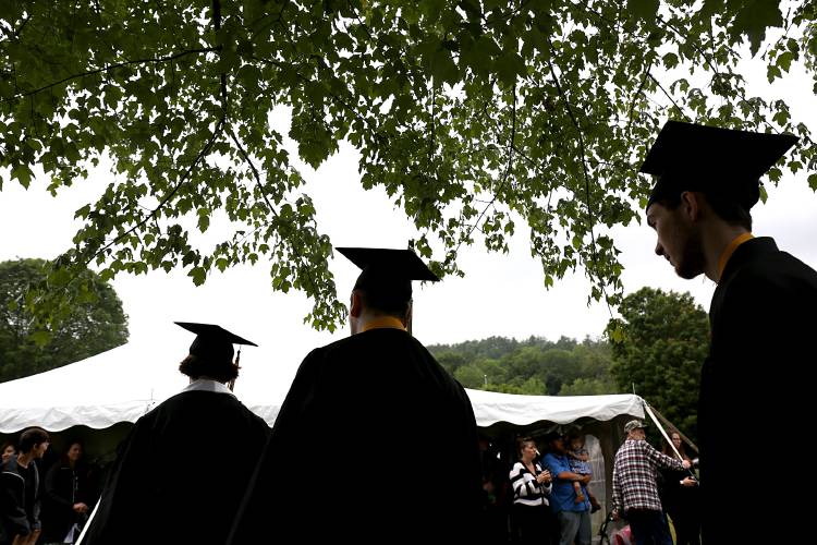 As the rain starts to fall, graduates walk into the tent for White River Valley High School’s commencement ceremony in South Royalton, Vt., on June 17, 2023. (Valley News - Geoff Hansen) Copyright Valley News. May not be reprinted or used online without permission. Send requests to permission@vnews.com.