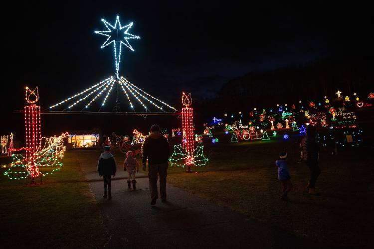 Visitors enter the festival of light display at the Shrine of Our Lady of La Salette in Enfield, N.H., on Thursday, Dec. 1, 2022. The annual light display begins on Thanksgiving and is open to the public from Wednesday through Sunday during the holiday season. (Valley News / Report For America - Alex Driehaus) Copyright Valley News. May not be reprinted or used online without permission. Send requests to permission@vnews.com.