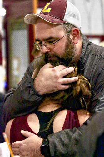 Lebanon High wrestling coach Chauncey Wood hugs 120-pound competitor Abigail Stone after she pinned Manchester West's Samuel Cruz. Stone avenged an earlier loss to Cruz during a 17-team tournament on Dec. 30, 2023, in Lebanon, N.H. (Valley News - Tris Wykes) Copyright Valley News. May not be reprinted or used online without permission. Send requests to permission@vnews.com.