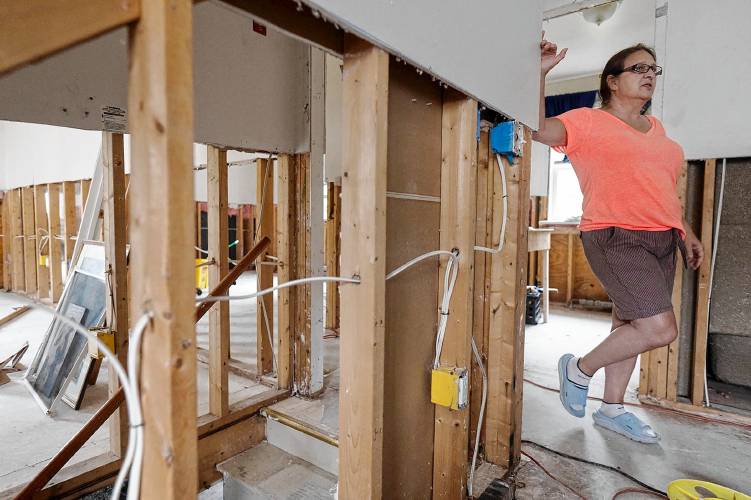 Jeane Wolfe stands in the flood-damaged home she shares with Jerry Williams in Johnson, Vt., on Wednesday, July 27, 2023. (VtDigger - Glenn Russell)